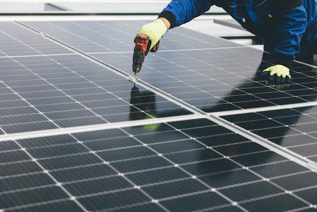 Man screwing on solar panels